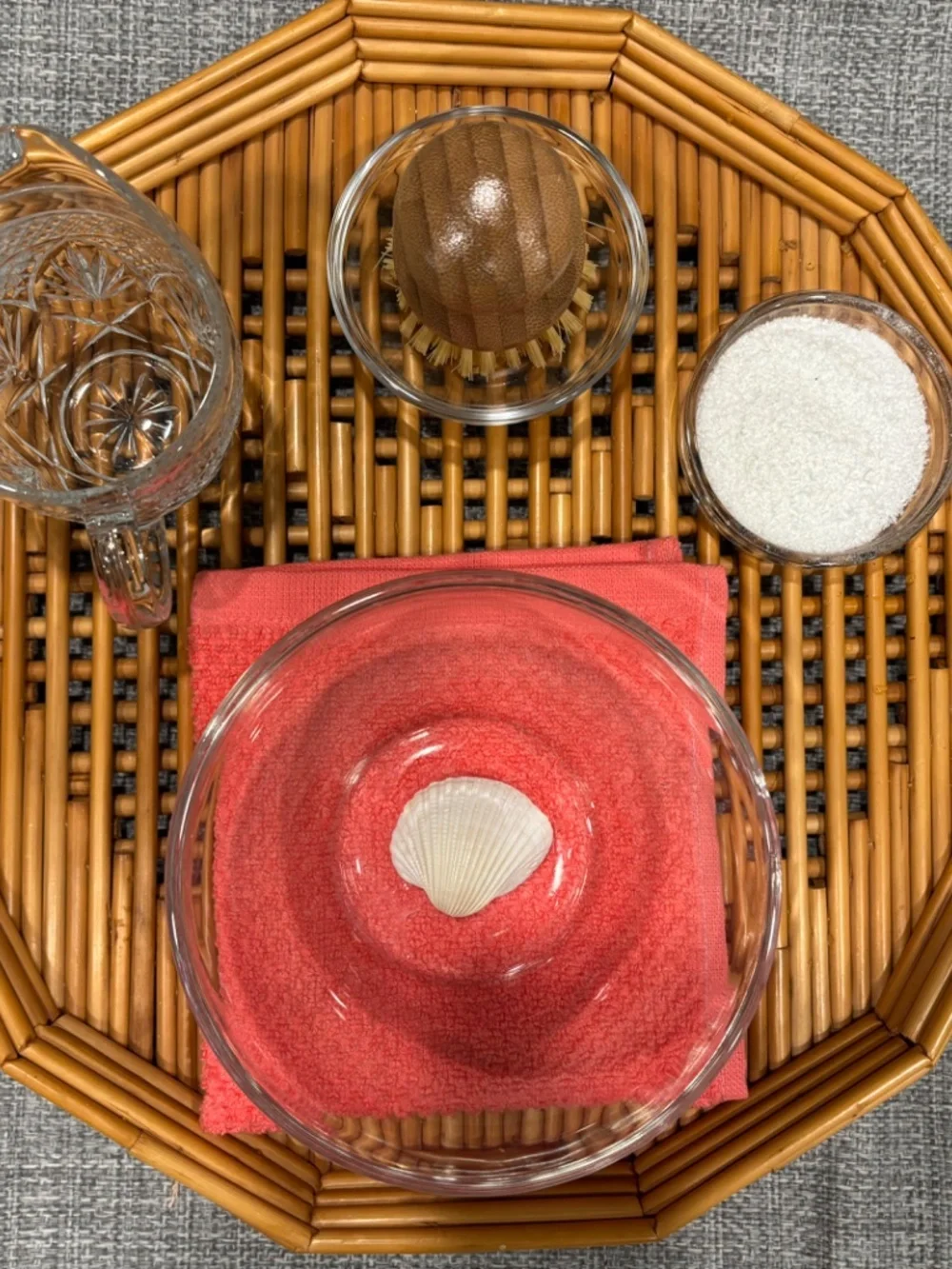 care of environment scrubbing a small object w/ seashell by idlewild montessori